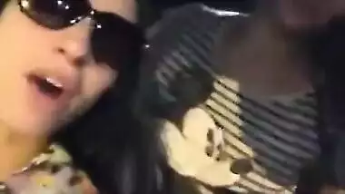 Two hot babes flash there boobs and kiss each other in moving ca