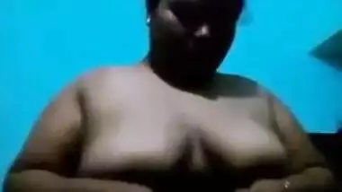 Mature Desi in a red sari exposes her big sex parts in a XXX show