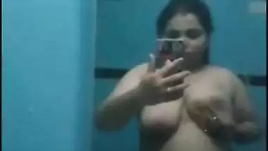 Desi sweet thing touches soft natural breasts in front of a mirror