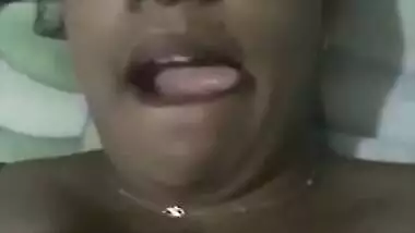 Indian aunty with sexy full lips takes big natural boobs out in bed