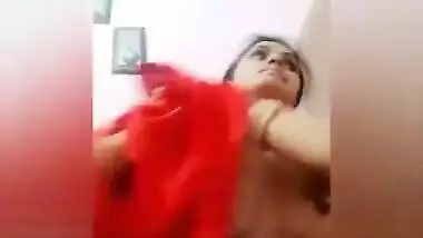 Young woman smiles on camera and changes clothes in sex video show