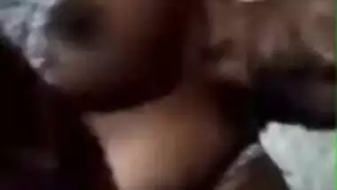 Tanned Desi girl lies in bed stripping XXX boobies for old pervert