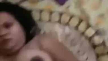 Desi woman lies in bed with legs spread while man touches XXX parts